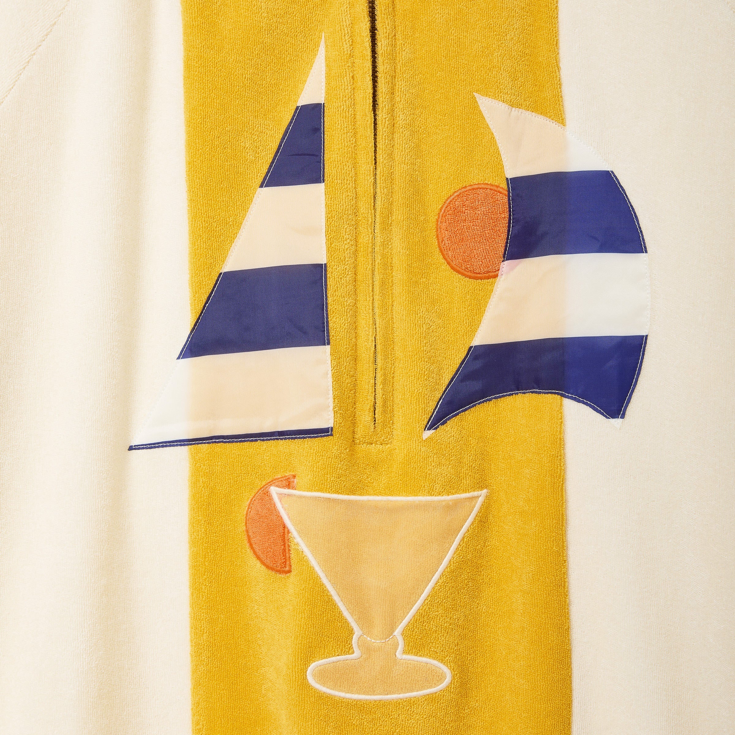 Yellow towel with sailboat and cocktail design on a beige background