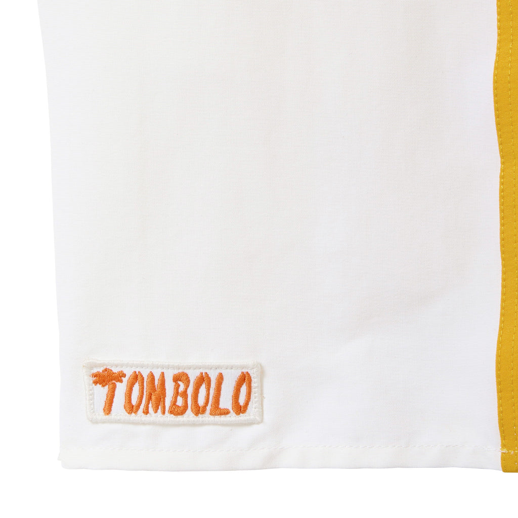 White trunks with orange 'Tombolo' logo 