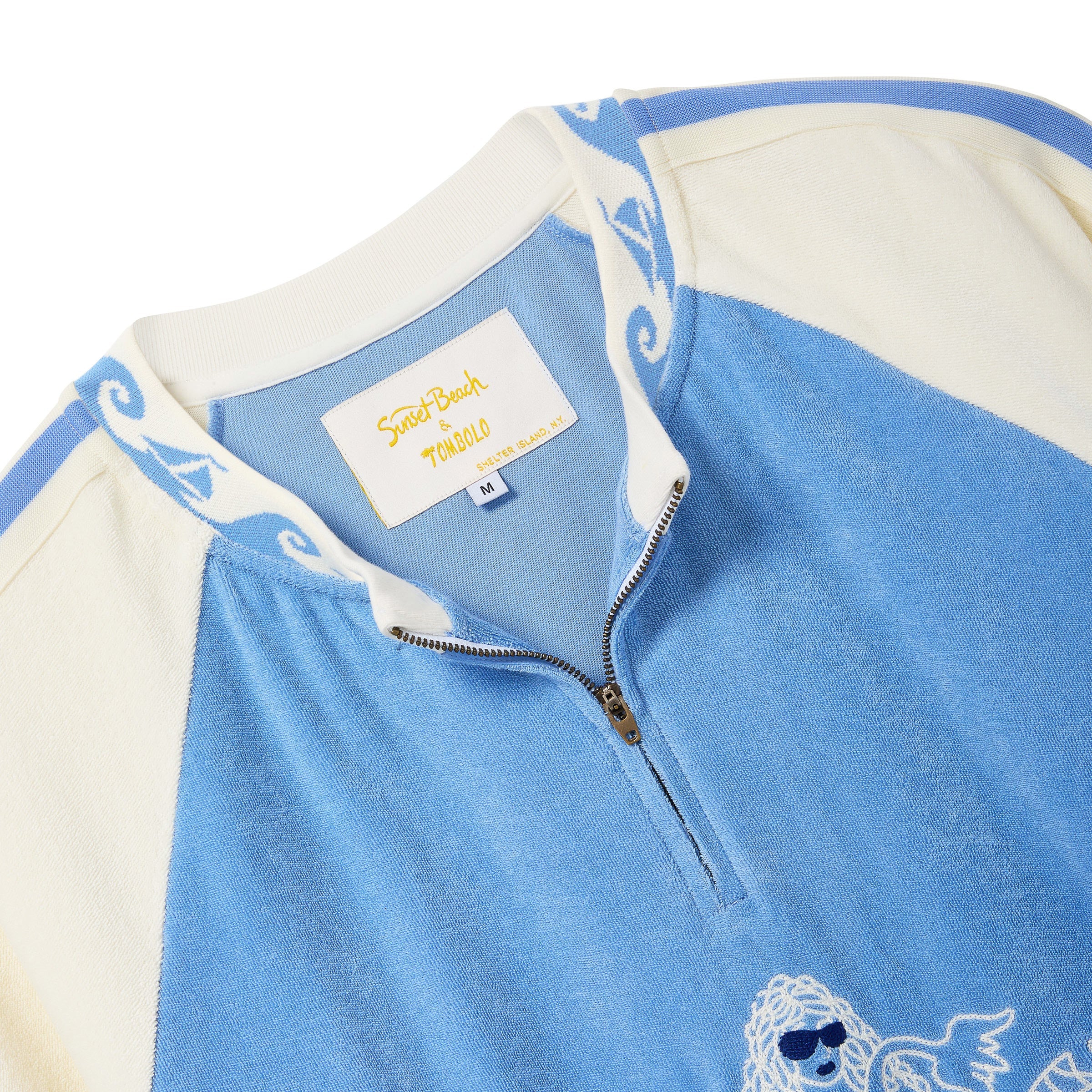 Close-up of a light blue and cream quarter-zip cabana shirt